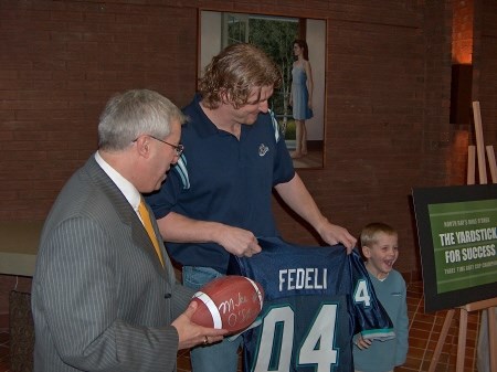 Mike O'Shea presents Mayor Vic Fedeli an  Argo Jersey and a autographed football.  Ball will be auctioned for charity. Photo by Chris Dawson.
