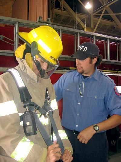 North Bay Fire Fighter Chris Curthbertson helps WSS grade 10 student Sam Kilgor suit up.