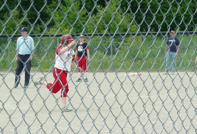 Jen Rothwell of Investor's Group rounds the bases after hitting a home run in the Bantam/Midget game.