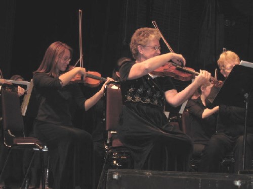 Concertmaster Mary Kozak (front row) and violinist Denise Cracknell (behind Kozak) are part of the North Bay Symphony's 19-piece violins section.