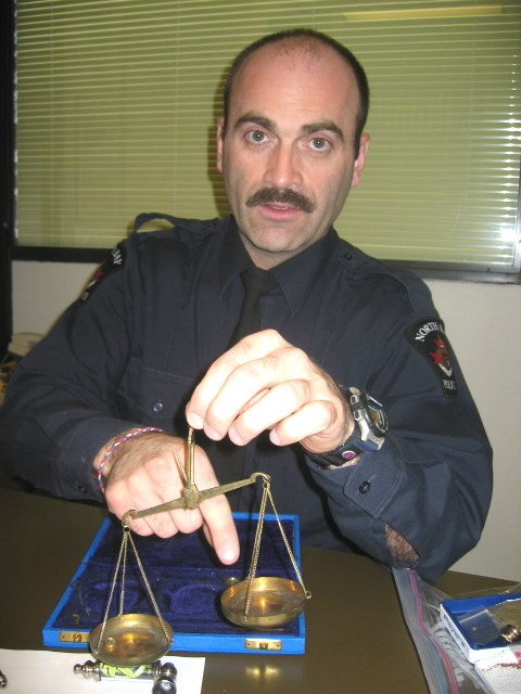 Cst. Paul Trahan displays a hand scale seized when he arrested a drug trafficker at a North Bay high school.
