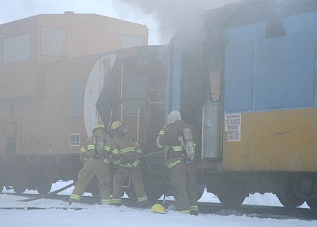 <br>North Bay fire fighters in action Tuesday evening when a fire broke out on a train sitting on the old CP Rail tracks. Photo by Marc Archambault - Northshore Developments