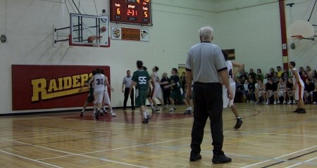 <b>Trojans go up for a rebound in the first quarter.  Photo by Chris Dawson.</b>