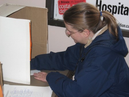 <b>A woman marks her referendum ballot today at the offices of the North Bay Health Coalition. Photo by Phil Novak, BayToday.ca.</b>
