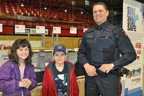 Jaydan and Payton McLeod, along with North Bay Police Services, D.A.R.E. Officer - Raymond Yelle spent time checking out the Ontario Power Generation "Stay Clear Stay Safe" model generating station - one of the many pit stops at the event. Photo by Jaydan and Payton McLeod, along with North Bay Police Services, D.A.R.E. Officer - Raymond Yelle (in photo) spent time checking out the Ontario Power Generation "Stay Clear Stay Safe" model generating station - Photo by Jeff Fournier