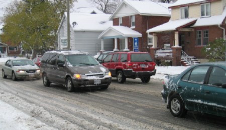 Traffic moves slowly along Fisher Street due to snow and freezing rain which hit North Bay Tuesday.