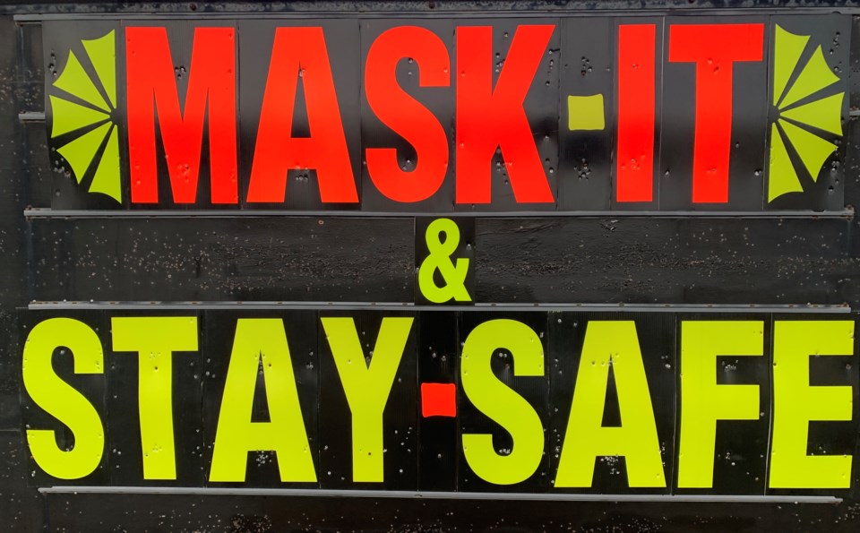 20201119 covid mask it and stay safe sign stock