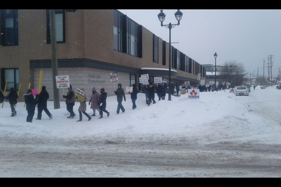 Protesters with their signs outside the North Bay Parry Sound District Health Unit. Photo submitted. 