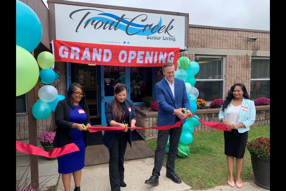 Belisha Ke (middle) and Paul Heinrich, North Bay Hospital CEO, cut the ribbon at the Grand Opening of Trout Creek Senior Living.  Photo by Chris Dawson/BayToday. 