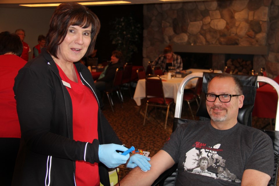 RN Shelley Hrycay prepares Chris Kelly to give blood. Chris has donated 148 times, beginning when he was 18 years old. Photo by Jeff Turl.