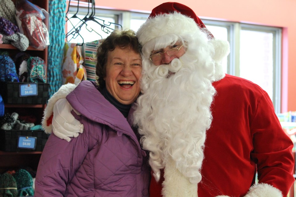  Patron Debbie Smith giving Santa a big hug and learning that she is on the 'naughty list'.