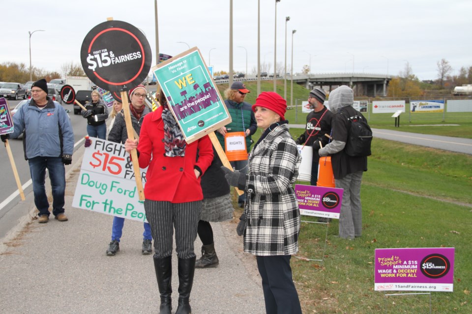 Minimum wage protesters congregate on the corner of Lakeshore and Judge.  Photo by Chris Dawson/BayToday.ca  