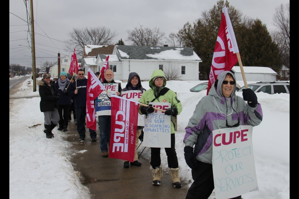 Workers on strike against the Canadian Hearing Society were joined by members of the locked out Children's Aid Society this morning on their picket line on King St. W. Photo by Jeff Turl.