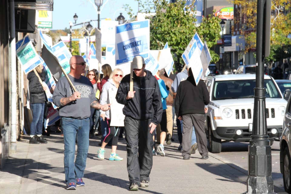 Canadore faculty march down Main St. Photo by Chris Dawson