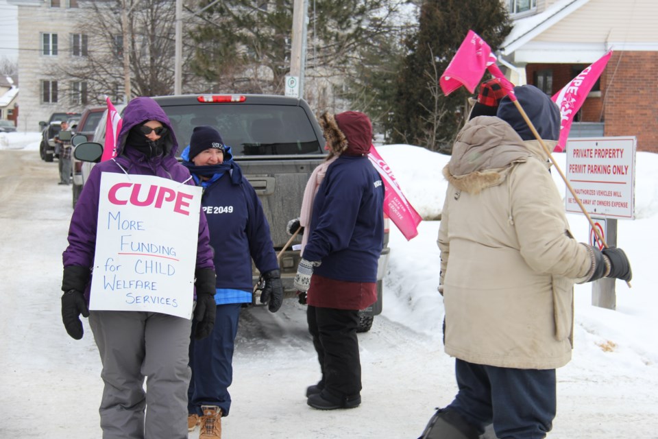 Locked out Children's Aid society workers picket outside the office on Main St. West. Photo by Jeff Turl.