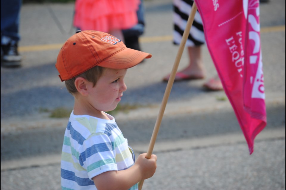 This young parade participant took his duties very seriously. Photo by Stu Campaigne