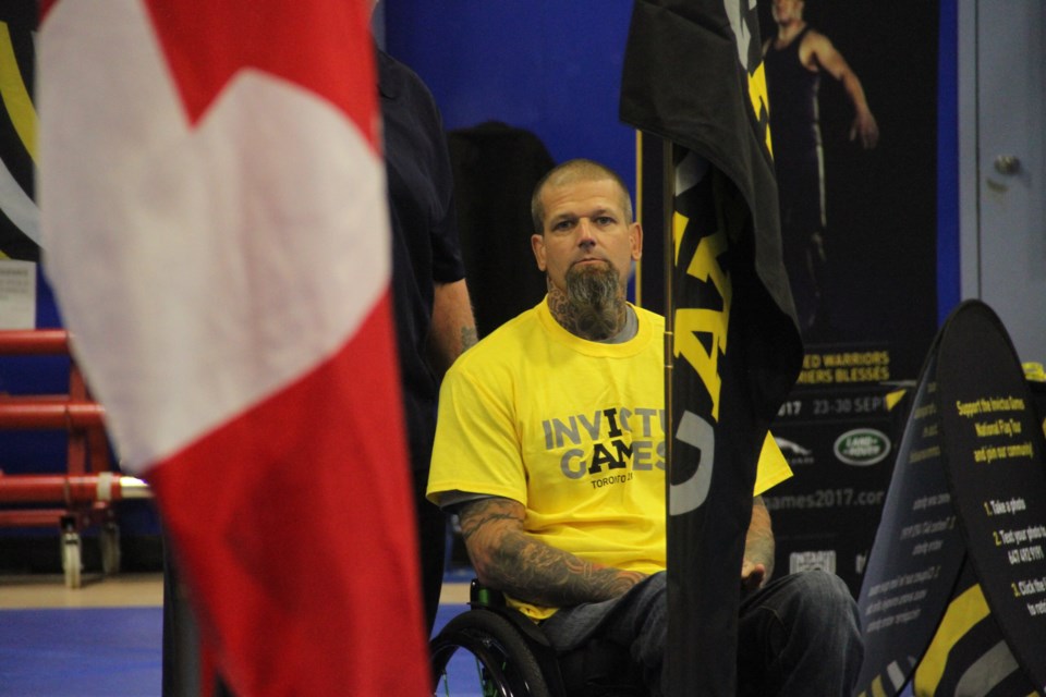 David Innes with the 2017 Invictus Games flag. Photo by Hannah Knight. 