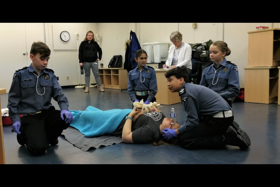 First Aid Team in action.  The scenario the cadets faced was a possible arm fracture, while their coach, Jennifer Proulx, and judge look on. Cadets on the bronze medal team are First Aid Captain Matthieu Berube and team members Isabelle Berube, Olivia Behe, Jakob Lacourse. Not pictured are Brooke and Hunter Doucette. Submitted.