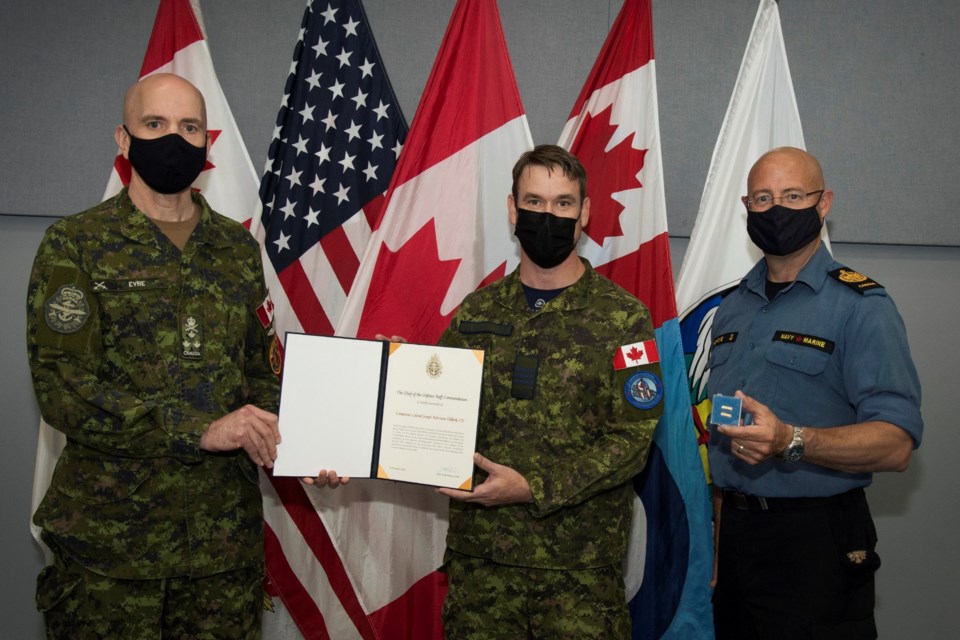 Lieutenant-General Wayne Eyre (left) presents Lieutenant Colonel Joseph Oldford with the Chief of Defence Staff Commandation, accompanied by Chief Warrant Officer Gilles Gregoire (right).  
Photo credit: Corporal Rob Ouellette, Imagery Technician.