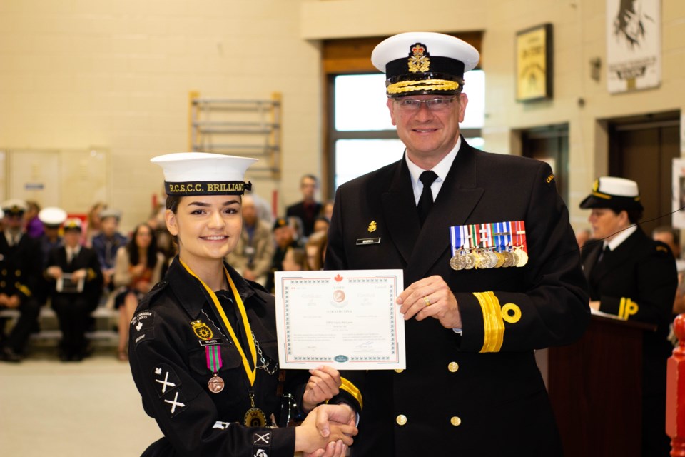 Chief Petty Officer Second Class 
 Emily McLaren receives an award from Commodore Steve Waddell. Courtesy Creative Eye Photography.