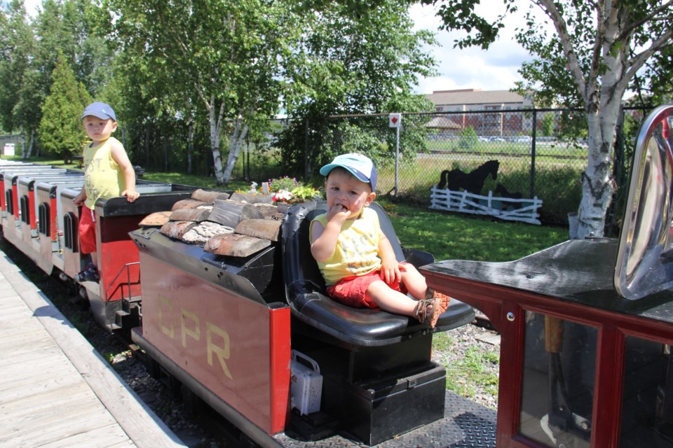 USED 170810 4 Emmett Ladoucer,1, and brother Elliott 2,of Lafontaine, Ont. love the mini train. Photo by Brenda Turl for BayToday.