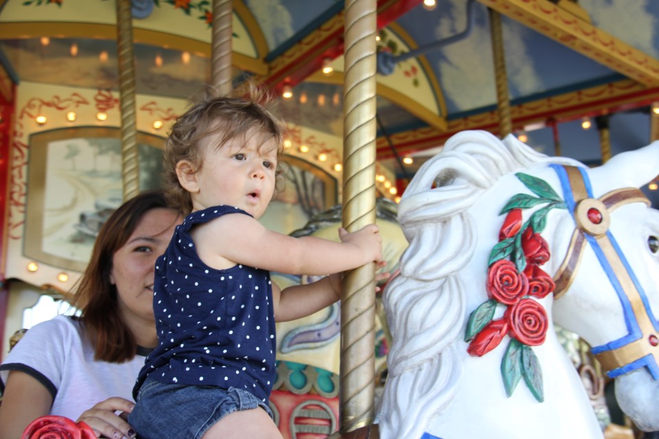 USED 170720 8 Tommie Lafrance-Morin, 14 month. ,Thorne enjoys a carousel ride with Toni Lafrance.. Photo by Brenda Turl for BayToday.