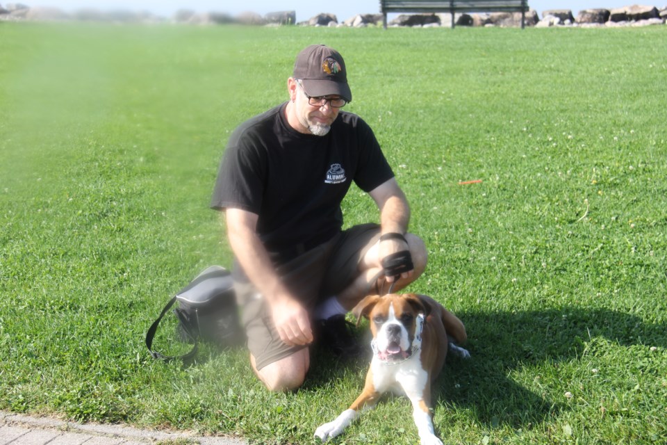 USED170928 03 Mike Brear and his 6 month old  Boxer,Roenick. Photo by Brenda Turl for BayToday.