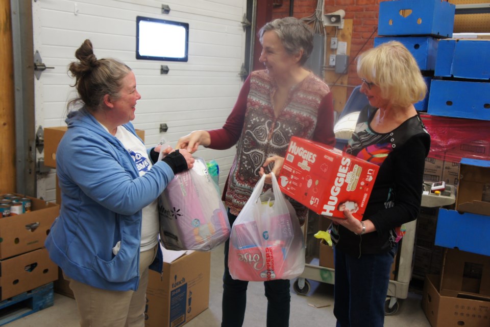 IODE North Bay Chapter President Heather Stuart (Centre) and Susan Reid (Right) donating diapers and hygiene products to the Food Bank. Photo provided by Pat Moulson.      