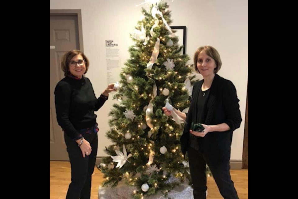 PADDLE Program Treasurer Judy Camirand (right) and Board Member Tracy Phillips during the Festival of Trees event at the North Bay Museum. Photo provided by the PADDLE Program. 