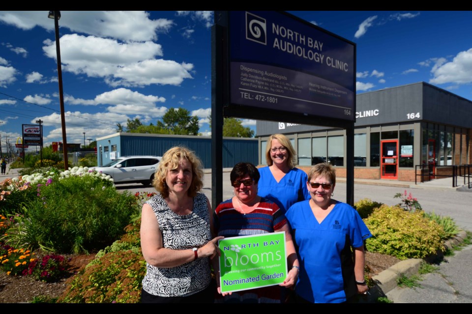 North Bay Blooms Chair Geri Openshaw, with owner Judy Bertrand and two unidentified employees. Submitted photo.