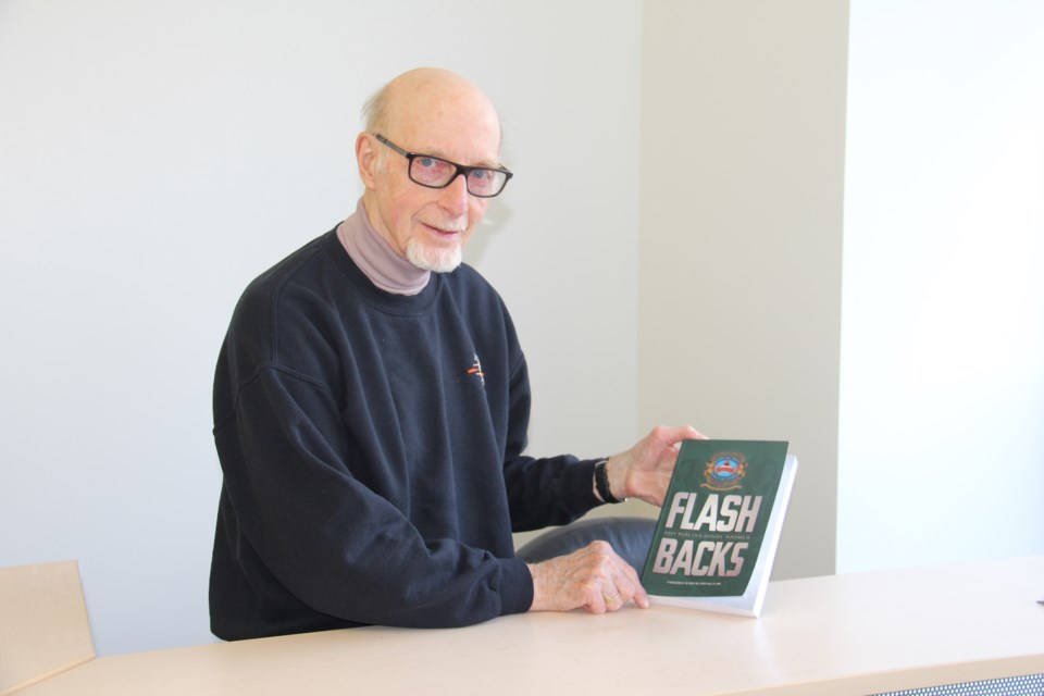 Pete Handley shows off his new book called Flashbacks.