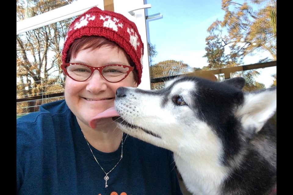 Naomi Sanderson wearing one of her Paw Hat creations with Sherlock. Submitted.