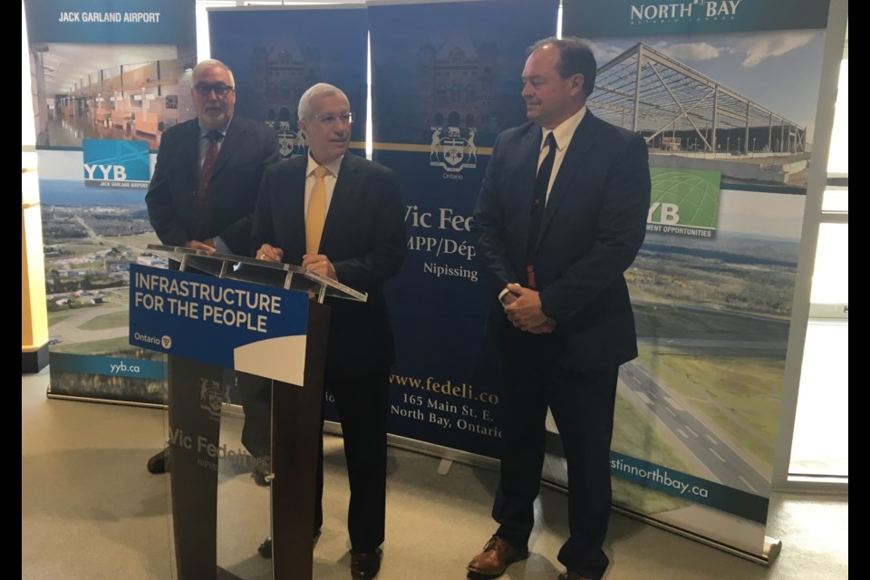 Nipissing MPP Vic Fedeli makes the runway announcement with Jack Santerre, Airport Manager (left) and North Bay Mayor Al McDonald. Chris Dawson/BayToday
