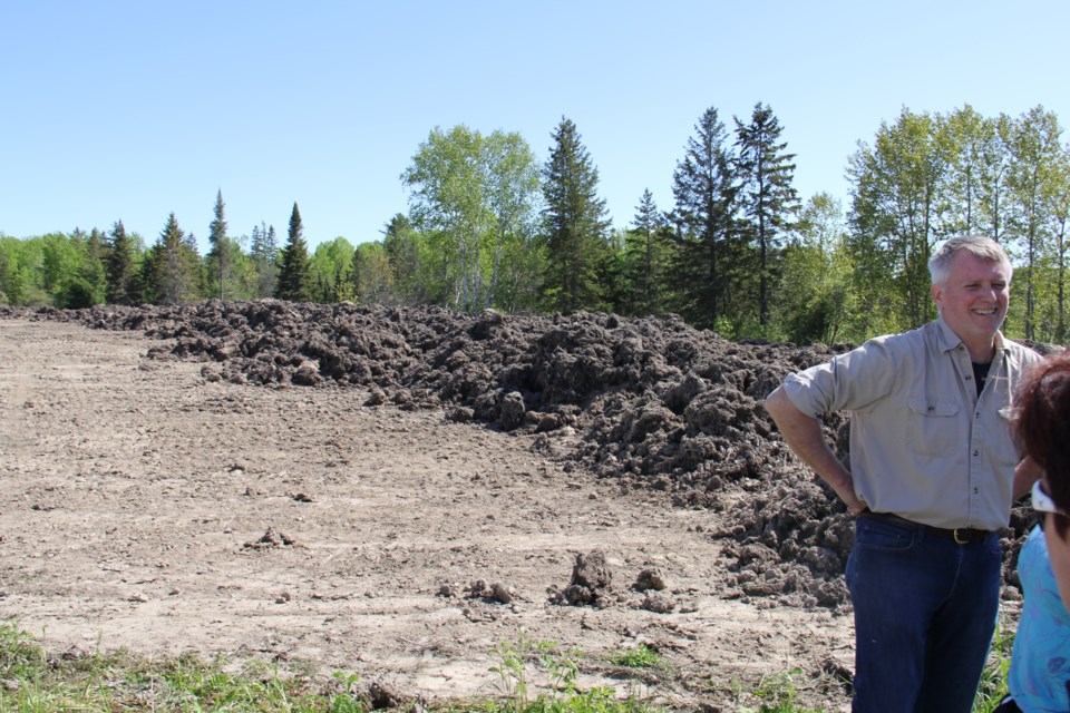 Land surveyor Paul Goodridge stands in front of the mounds of soil from the casino site that has been dumped on a property nearby. Jeff Turl/BayToday.