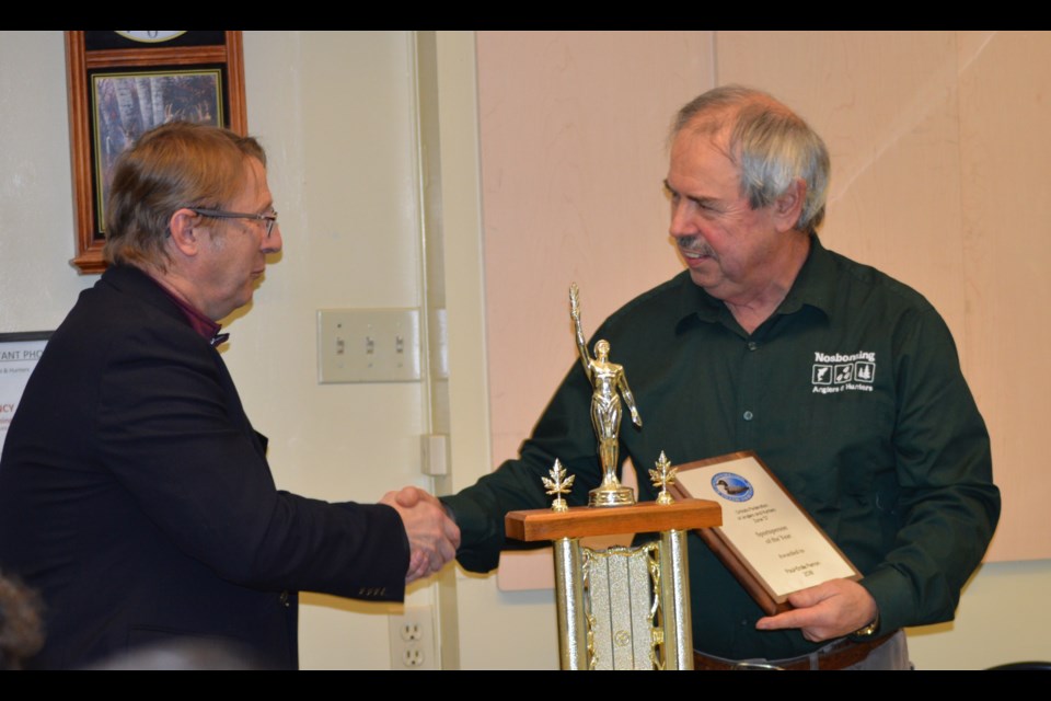 Gerry Geisler, 1st Vice of Zone D OFAH congratulates Paul-Emile Perron on his achievement, Supplied. 