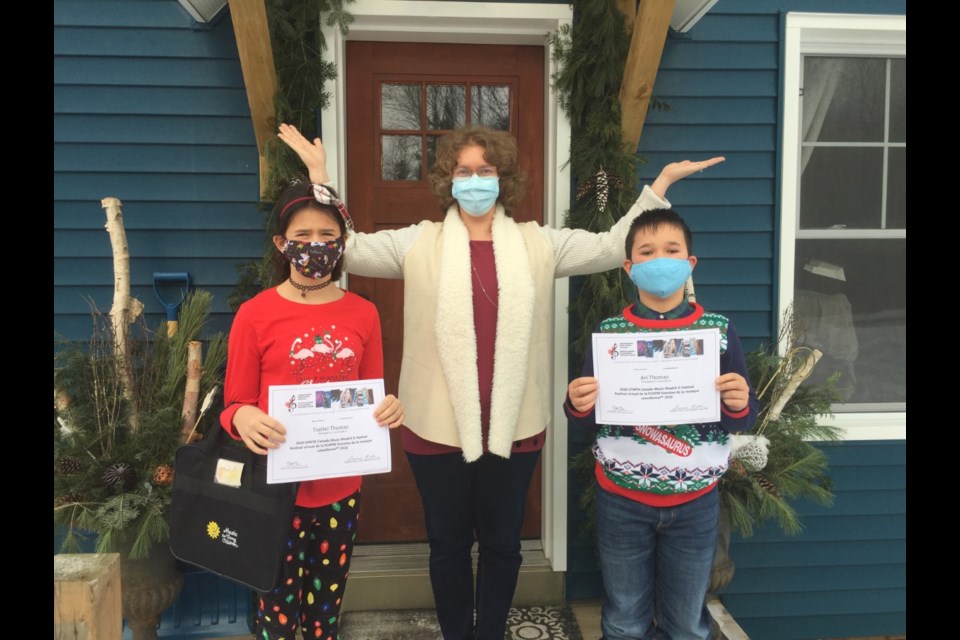 Jennifer Levitan with 2 of her students holding certificates for completing the CFMTA (Canadian Federation Music Teacher's Association) Canadian Compose E-Festival in November. Photo provided by Jennifer Levitan. 