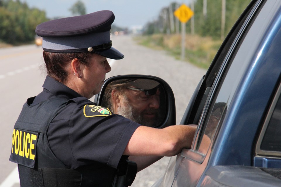 2015 9 24 Const Grassie speaks with a driver, nabbed by the plate scanning technology turl