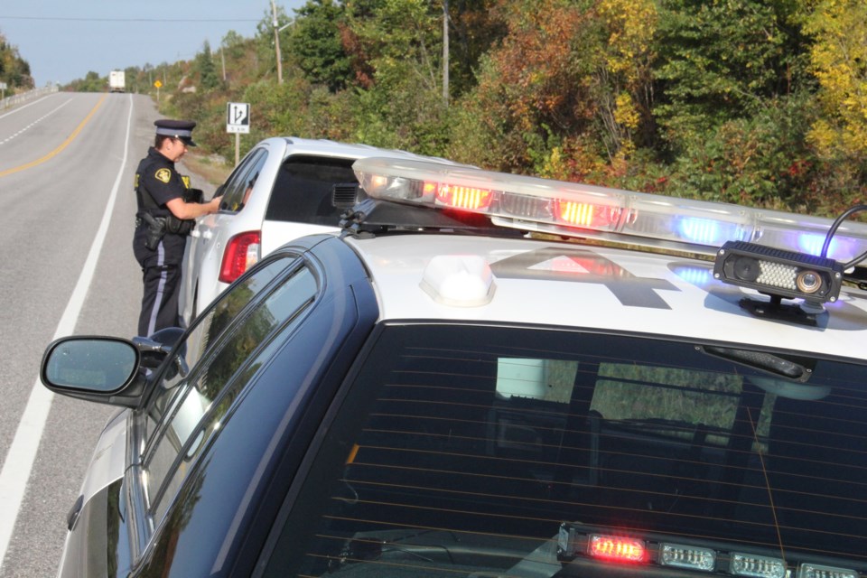 Constable Jeannine Grassie speaks with a driver pulled over because of an expired plate sticker. Notice the camera on the roof of the cruiser. Photos by Jeff Turl.