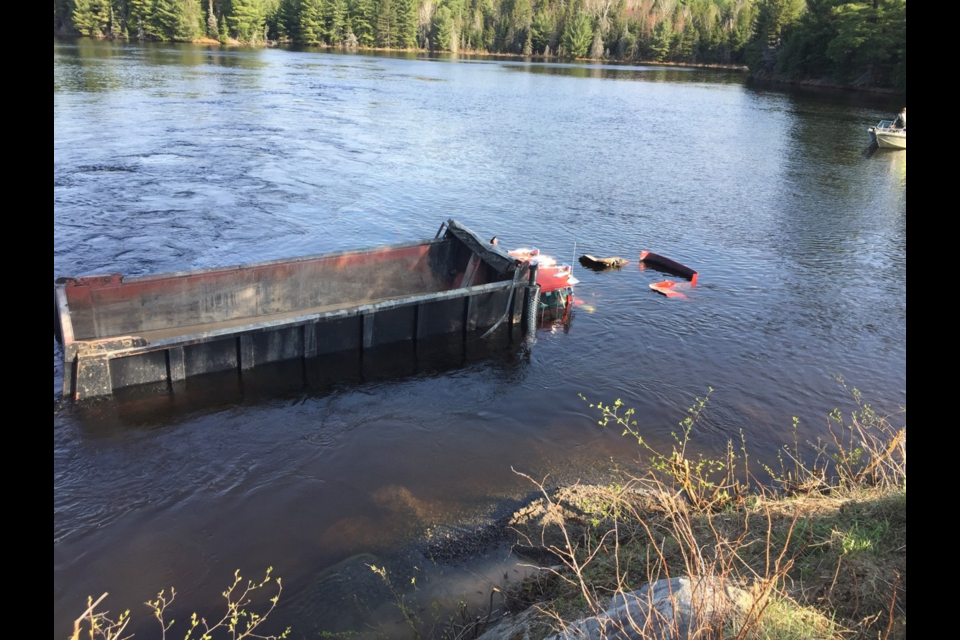 This dump truck ended up in the Marten River after hitting a bridge. Courtesy OPP.