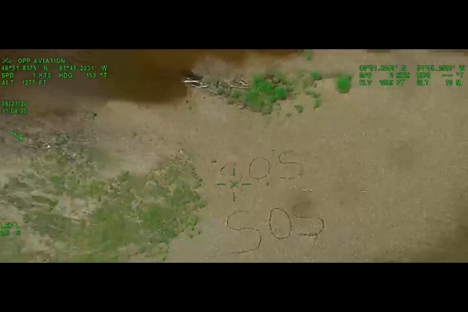 The woman wrote SOS in beach sand hoping to be rescued. Courtesy OPP.