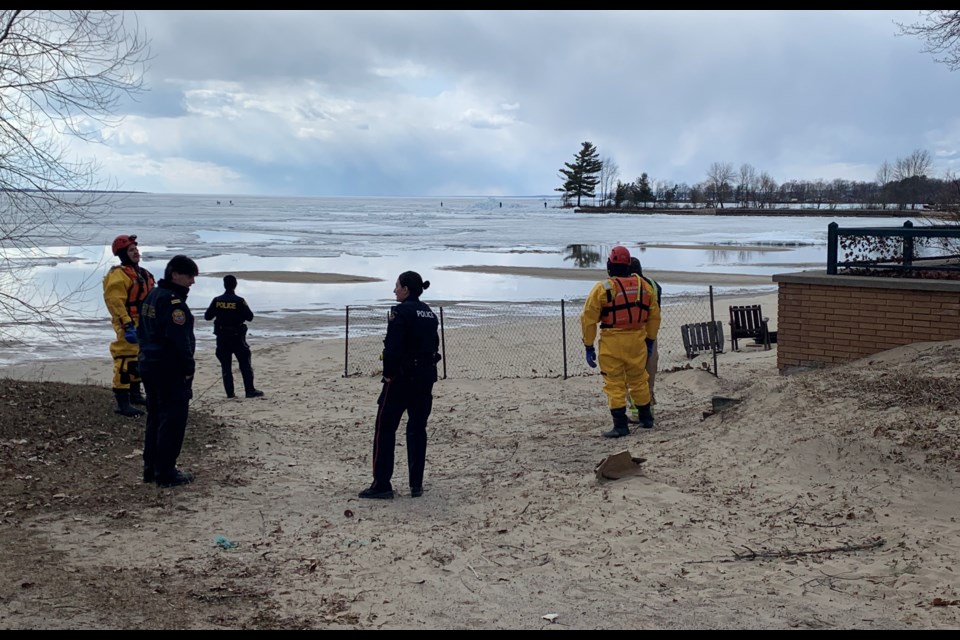 Firefighters in full rescue gear wait anxiously on shore as teens, seen in the background put their lives at risk. Jeff Turl/BayToday.