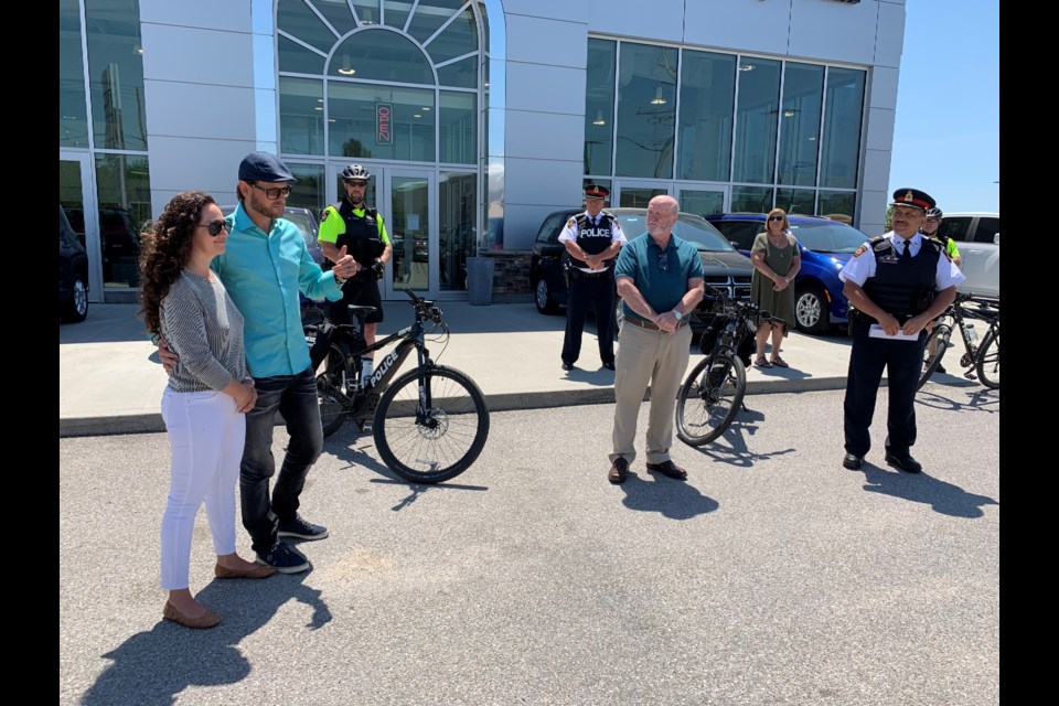 Ryan Farquhar and his wife Erin talk during a media conference announcing their donation of two EBikes to the North Bay Police Service.  Photo by Chris Dawson/BayToday. 