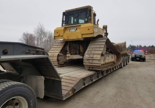 Nothing holding this 26 ton bulldozer to the flatbed trailer.