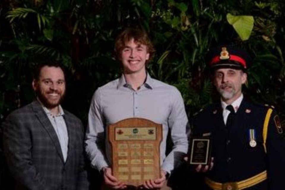 Andrew Keating Memorial Award was presented to Griffen Duncalfe of the men's volleyball team. Det. Cst. Steve Carleton is left and Inspector Jeff Warner is on the right.