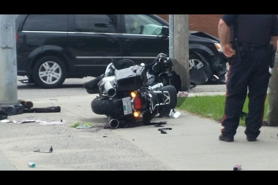 This motorcycle and van collision has sent two people to hospital. The van is in the background. Photo by Stu Campaigne.