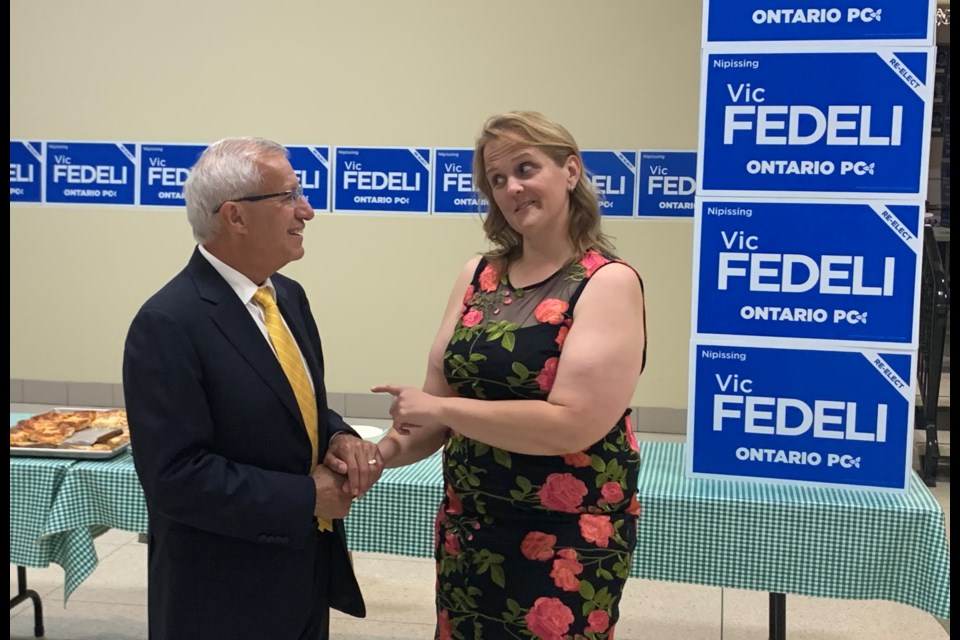 Vic Fedeli is congratulated by Liberal candidate Tanya Vrebosch.