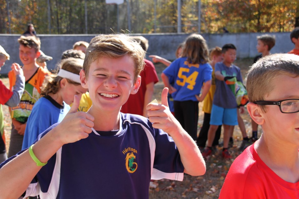 Heritage's Beau Herron with a double thumbs up after the grade six boys race.  Photo by Hannah Knight. 