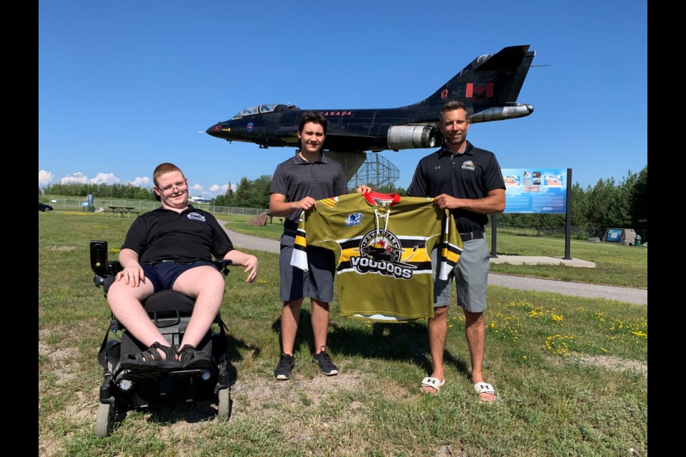 Voodoos northern scout Dillon Anderson (far left), new Voodoos recruit Ben White (middle) and Voodoos assistant coach Josh Dale (right) stand in front of a CF-101 Voodoos Jet at CFB North Bay.    