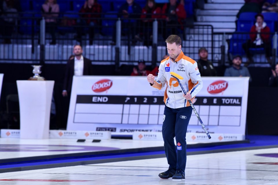 Brad Gushue with a fist pump on his way to the winner's circle.