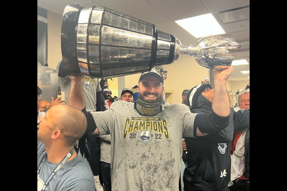 Ryan Hunter celebrates with the Grey Cup in the locker room. Photo courtesy Facebook. 